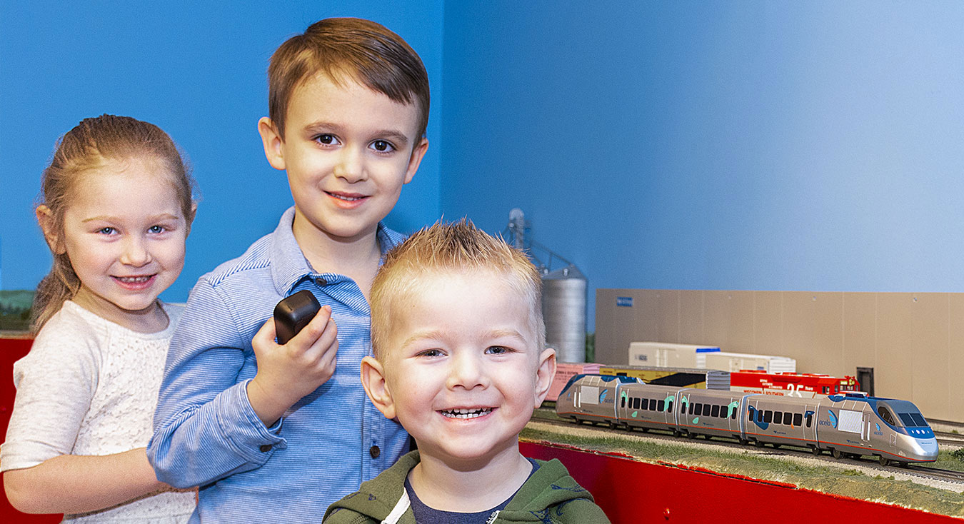 Children playing with trains as part of autism therapy